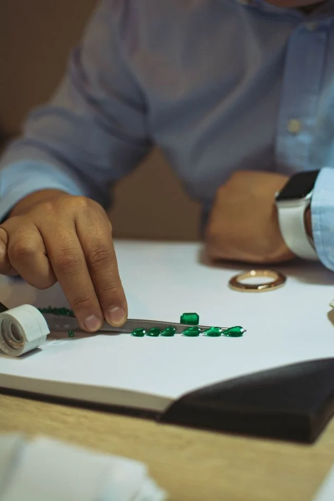 man looking at colombian emeralds 13613422